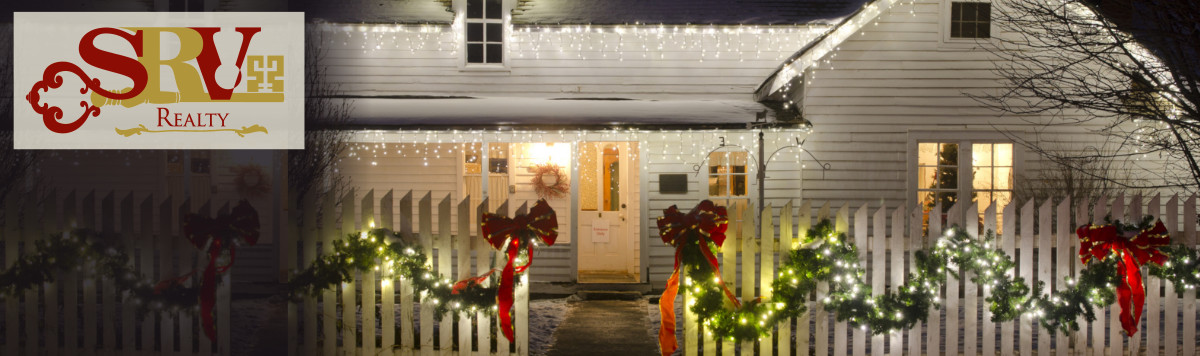 A large white house decked out for the holidays